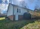 Backyard view of a light blue home featuring a wooden deck and well-maintained yard at 121 Deertrack Dr, Mount Holly, NC 28120