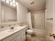 Neutral bathroom featuring a vanity with sink, toilet, and shower/tub combination at 121 Deertrack Dr, Mount Holly, NC 28120