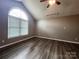 Vaulted ceilings and a large arched window brighten this spacious bedroom at 121 Deertrack Dr, Mount Holly, NC 28120