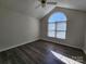 Vaulted ceilings and a large arched window brighten this spacious bedroom at 121 Deertrack Dr, Mount Holly, NC 28120