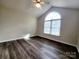 Bright bedroom featuring modern flooring and a large arched window at 121 Deertrack Dr, Mount Holly, NC 28120