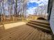 Spacious wooden deck with railing, perfect for outdoor entertaining with trees in the background at 121 Deertrack Dr, Mount Holly, NC 28120