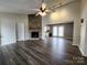 Living room showcasing a cozy fireplace, modern lighting, and smooth vinyl flooring at 121 Deertrack Dr, Mount Holly, NC 28120