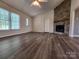 Open living room layout with fireplace and vinyl floors and ample space for furniture at 121 Deertrack Dr, Mount Holly, NC 28120