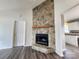 Living room featuring a stone fireplace, modern flooring, and a cozy atmosphere at 121 Deertrack Dr, Mount Holly, NC 28120