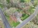 Aerial view of the property featuring a pool, mature trees, and a large lot at 1501 Laurel Ln, Gastonia, NC 28054