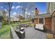 Back deck overlooks the lawn and surrounding trees, perfect for relaxing or entertaining at 1501 Laurel Ln, Gastonia, NC 28054
