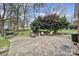 Back patio features mature landscaping, patio furniture, and a barbecue at 1501 Laurel Ln, Gastonia, NC 28054