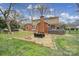 Sprawling backyard with a brick patio, outdoor dining and a mature shade tree at 1501 Laurel Ln, Gastonia, NC 28054