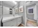 Bathroom features a large mirror, modern vanity, tiled shower, and window for natural light at 1501 Laurel Ln, Gastonia, NC 28054
