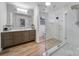 Modern bathroom boasts dual sinks, a spacious glass shower, and wood look flooring at 1501 Laurel Ln, Gastonia, NC 28054