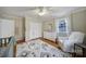 Bright bedroom with hardwood floors, white furniture, and a ceiling fan at 1501 Laurel Ln, Gastonia, NC 28054
