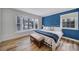 Bright bedroom with large bay window, blue accent wall, and decorative wooden bench at 1501 Laurel Ln, Gastonia, NC 28054