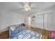 Bright bedroom features wood floors, a ceiling fan, shiplap walls and a play rug for children at 1501 Laurel Ln, Gastonia, NC 28054