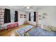 Playful bedroom with a ceiling fan, hardwood floors, and ample natural light at 1501 Laurel Ln, Gastonia, NC 28054
