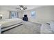 Large bedroom with a ceiling fan, blue dresser and two large windows at 1501 Laurel Ln, Gastonia, NC 28054