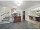 Inviting foyer featuring slate flooring, a wooden staircase, and views into the dining and living spaces at 1501 Laurel Ln, Gastonia, NC 28054