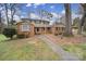 Inviting brick home featuring a covered porch and a landscaped front yard at 1501 Laurel Ln, Gastonia, NC 28054
