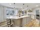 Bright, updated kitchen with a spacious island, white cabinets, modern lighting, and stainless appliances at 1501 Laurel Ln, Gastonia, NC 28054
