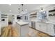 Updated kitchen featuring stainless steel appliances, a central island, and a view to the living area at 1501 Laurel Ln, Gastonia, NC 28054