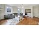Cozy living room with wood floors, a comfortable gray sofa, and a convenient laundry area at 1501 Laurel Ln, Gastonia, NC 28054