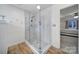 Bright and modern bathroom shower has white tile and new fixtures at 1501 Laurel Ln, Gastonia, NC 28054