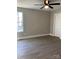 The bedroom has neutral walls, new floors, a ceiling fan and natural light at 1537 Poston Cir, Gastonia, NC 28054