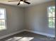 A well-lit bedroom featuring two windows and a ceiling fan at 1537 Poston Cir, Gastonia, NC 28054