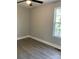 Sunlit bedroom with hardwood-style flooring and two windows at 1537 Poston Cir, Gastonia, NC 28054