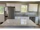 New kitchen with granite counters, ample storage, stainless appliances, and island at 1537 Poston Cir, Gastonia, NC 28054