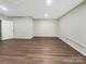 Spacious basement space with neutral walls, vinyl wood flooring, and an interior door at 15827 Arabian Mews Ln, Charlotte, NC 28278