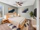 Cozy bedroom featuring stylish decor, a ceiling fan, plush carpet, and ample natural light at 15827 Arabian Mews Ln, Charlotte, NC 28278
