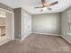 Bedroom boasts neutral walls, carpet, ceiling fan, one window, closet, and an interior door at 15827 Arabian Mews Ln, Charlotte, NC 28278