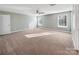 Large bedroom with carpet, two windows and a ceiling fan at 15827 Arabian Mews Ln, Charlotte, NC 28278