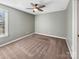 Empty bedroom featuring plush carpet, a ceiling fan, and a window providing natural light at 15827 Arabian Mews Ln, Charlotte, NC 28278