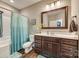 Traditional bathroom featuring a vanity with lots of storage and a tub/shower with a decorative curtain at 1823 Rain Forest Dr, York, SC 29745