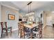A dining area features an elegant chandelier, wood table and chairs and is open to the kitchen and living spaces at 1823 Rain Forest Dr, York, SC 29745
