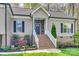 Close-up of the entryway with brick steps, white railing, and attractive front door at 1823 Rain Forest Dr, York, SC 29745