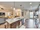 Open-concept kitchen with granite countertops, stainless steel appliances, and island seating at 1823 Rain Forest Dr, York, SC 29745