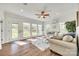 Bright and airy sunroom featuring hardwood floors, large windows, and comfortable seating, perfect for relaxing and entertaining at 1823 Rain Forest Dr, York, SC 29745