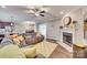 Open-concept living room with fireplace, hardwood floors, and seamless flow to other living spaces at 1823 Rain Forest Dr, York, SC 29745