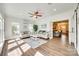 Bright living room with hardwood floors, a ceiling fan, and comfortable seating, seamlessly connected to an adjacent living area at 1823 Rain Forest Dr, York, SC 29745