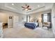 Spacious main bedroom features plush carpeting, tray ceiling, fan, and neutral tones, creating a serene and inviting retreat at 1823 Rain Forest Dr, York, SC 29745