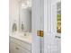 Bathroom with a white vanity, decorative lighting, and a linen closet at 207 Crossing Ave, Belmont, NC 28012