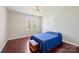 Bedroom featuring hardwood floors, a ceiling fan, a window, and a blue bed at 207 Crossing Ave, Belmont, NC 28012
