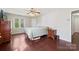 Bedroom with hardwood floors, ceiling fan, and natural light from the window at 207 Crossing Ave, Belmont, NC 28012