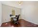 Bedroom featuring hardwood floors, a ceiling fan, a window, and a desk at 207 Crossing Ave, Belmont, NC 28012