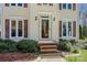 Close-up of the front entrance featuring a decorative glass door, brick steps, and classic exterior lighting at 207 Crossing Ave, Belmont, NC 28012