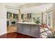 Bright kitchen boasts gray cabinets, an island, and a view of the sunroom at 207 Crossing Ave, Belmont, NC 28012