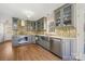 This kitchen is complete with stainless appliances and stylish cabinetry at 207 Crossing Ave, Belmont, NC 28012